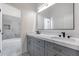 Bathroom showcasing double sink vanity, marble countertop, and tub at 21663 N 57Th Ave, Glendale, AZ 85308