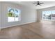 Spacious bedroom featuring light wood floors, ceiling fan, and a view of the canal at 21663 N 57Th Ave, Glendale, AZ 85308