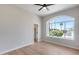 Bright bedroom featuring large arched window, neutral paint, and hardwood floors at 21663 N 57Th Ave, Glendale, AZ 85308