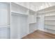 Spacious walk-in closet with built-in shelving and wood flooring, offering plenty of storage at 21663 N 57Th Ave, Glendale, AZ 85308