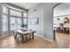 Bright dining room featuring a wooden table, large windows, and views of the waterfront at 21663 N 57Th Ave, Glendale, AZ 85308