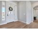 Bright entryway featuring wood flooring and a front door with sidelights at 21663 N 57Th Ave, Glendale, AZ 85308