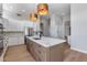 Spacious kitchen featuring a large island, stainless steel appliances, and modern lighting fixtures at 21663 N 57Th Ave, Glendale, AZ 85308