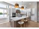 Well-lit kitchen showcasing a large island with seating, white cabinetry, and views from the large windows at 21663 N 57Th Ave, Glendale, AZ 85308