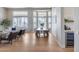Open-concept living room with dining area featuring large windows, modern furniture, and bright, neutral tones at 21663 N 57Th Ave, Glendale, AZ 85308