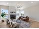Stylish living room with a fireplace, large windows showing waterfront views, and contemporary furniture at 21663 N 57Th Ave, Glendale, AZ 85308