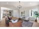 Open-concept living room featuring modern chandelier, neutral tones, and hardwood floors at 21663 N 57Th Ave, Glendale, AZ 85308