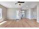 Spacious living room with hardwood floors, bright natural light, and modern ceiling fan at 21663 N 57Th Ave, Glendale, AZ 85308