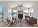 Comfortable living room with a fireplace, modern seating, and waterfront views from large windows at 21663 N 57Th Ave, Glendale, AZ 85308