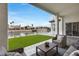 Inviting covered patio features comfortable seating, a manicured lawn and waterfront views at 21663 N 57Th Ave, Glendale, AZ 85308