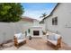 Cozy outdoor patio with fireplace and chairs, perfect for relaxing and entertaining in a private setting at 21663 N 57Th Ave, Glendale, AZ 85308