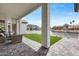 Beautiful backyard patio features seating, a water view and manicured turf at 21663 N 57Th Ave, Glendale, AZ 85308