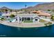Waterfront home with pool, covered patio, and artificial grass, perfect for outdoor living at 21663 N 57Th Ave, Glendale, AZ 85308