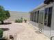 Spacious backyard showcasing low maintenance landscape and an enclosed sunroom at 2324 W Via Rialto Cir, Mesa, AZ 85202