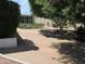 Backyard featuring mature trees and gravel, offers a peaceful outdoor retreat at 2324 W Via Rialto Cir, Mesa, AZ 85202