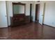 Open bedroom with parquet floors, a large mirror dresser, and multiple doorways at 2324 W Via Rialto Cir, Mesa, AZ 85202