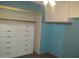 Bedroom with built-in drawers, wall cabinets, and blue walls at 2324 W Via Rialto Cir, Mesa, AZ 85202