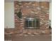Classic brick fireplace with glass doors and mantel in a cozy living area at 2324 W Via Rialto Cir, Mesa, AZ 85202
