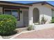 Single story home featuring desert landscaping and an arched covered porch and walkway at 2324 W Via Rialto Cir, Mesa, AZ 85202
