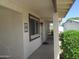 Charming front porch with brick accents, landscaped plants, a dark-brown window trim, and an address plaque at 2324 W Via Rialto Cir, Mesa, AZ 85202