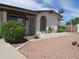 Charming home featuring a well-maintained front yard with gravel landscaping and mature plants at 2324 W Via Rialto Cir, Mesa, AZ 85202