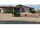 Inviting home exterior featuring a well-maintained yard, mature landscaping, and charming curb appeal at 2324 W Via Rialto Cir, Mesa, AZ 85202
