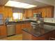 Bright kitchen with wood cabinets, stainless appliances, an island counter, and a window at 2324 W Via Rialto Cir, Mesa, AZ 85202
