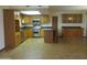 Bright kitchen features stainless steel appliances, wood cabinetry, an island, and lots of open space at 2324 W Via Rialto Cir, Mesa, AZ 85202