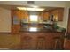 Kitchen features wood cabinetry, stainless steel appliances, and a kitchen island with seating at 2324 W Via Rialto Cir, Mesa, AZ 85202