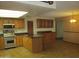 Spacious kitchen equipped with stainless steel appliances, wooden cabinets and an island with seating at 2324 W Via Rialto Cir, Mesa, AZ 85202
