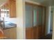 Storage area featuring wooden cabinets, countertops, decorative glass and an overhead light fixture at 2324 W Via Rialto Cir, Mesa, AZ 85202