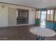 Large sun room featuring a tile floor, natural light, and access to the backyard at 2324 W Via Rialto Cir, Mesa, AZ 85202