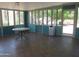 Inviting sunroom with tile floor, surrounded by bright windows, and bathed in natural light at 2324 W Via Rialto Cir, Mesa, AZ 85202