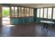 Bright sunroom with tile flooring, large windows, and a charming table, ideal for relaxation at 2324 W Via Rialto Cir, Mesa, AZ 85202