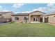 Backyard features artificial grass, gravel, and a covered patio at 23637 W Hopi St, Buckeye, AZ 85326