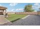 Spacious backyard features artificial grass, a gravel area, and brick pavers at 23637 W Hopi St, Buckeye, AZ 85326