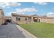 Backyard features gravel, artificial grass, and covered patio at 23637 W Hopi St, Buckeye, AZ 85326