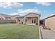 Spacious backyard features artificial grass, gravel, and covered patio at 23637 W Hopi St, Buckeye, AZ 85326