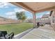 Covered patio opens to a spacious backyard with artificial grass and string lights at 23637 W Hopi St, Buckeye, AZ 85326