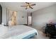 Bright bedroom with a ceiling fan and open door to the bathroom and stairway at 23637 W Hopi St, Buckeye, AZ 85326
