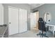Bedroom featuring sliding closet doors, neutral walls, and a well-lit vanity area at 23637 W Hopi St, Buckeye, AZ 85326