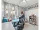 Cozy bedroom with neutral walls, ceiling fan, and window dressed with white curtains at 23637 W Hopi St, Buckeye, AZ 85326