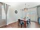 Stylish dining area with table, modern light fixture, and bright natural lighting at 23637 W Hopi St, Buckeye, AZ 85326