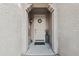 Welcoming front door featuring an arched entry, wreath, and elegant potted plant at 23637 W Hopi St, Buckeye, AZ 85326