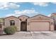 Charming single-story home featuring a two-car garage, landscaped yard, and a welcoming front entrance with wreath at 23637 W Hopi St, Buckeye, AZ 85326
