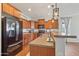 Well-equipped kitchen with stainless steel appliances, countertop seating, and ample cabinet space at 23637 W Hopi St, Buckeye, AZ 85326