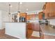 Bright kitchen features granite counters, stainless appliances, and a breakfast bar, perfect for modern living at 23637 W Hopi St, Buckeye, AZ 85326