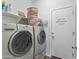 Practical laundry room featuring a washer, dryer, and storage shelf, maximizing utility and convenience at 23637 W Hopi St, Buckeye, AZ 85326