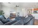 Comfortable living room with plush sectional couch, mounted TV, and wood floors at 23637 W Hopi St, Buckeye, AZ 85326