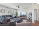 Comfortable living room with large sectional couch, fan, and large TV at 23637 W Hopi St, Buckeye, AZ 85326